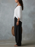 Alba | Conjunto de Top Blanco de Hombros Descubiertos y Pantalón Farol Negro